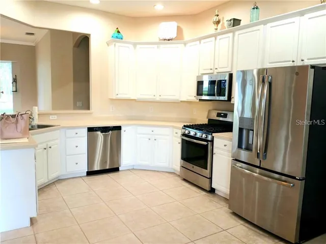 a kitchen with a refrigerator sink and microwave