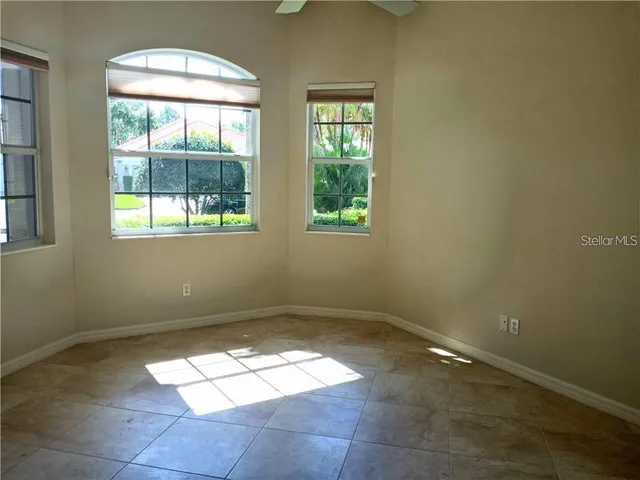 an empty room with a empty space and windows