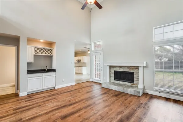 a view of empty room wooden floor and fireplace