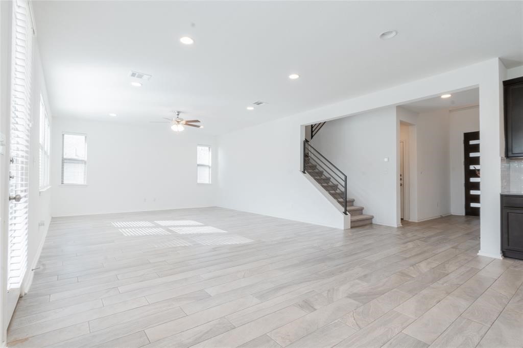 1333 Terrace View Drive Georgetown, TX 78628 - Photo 6 of 35 A spacious living area with sleek tiled flooring and a modern staircase awaits.