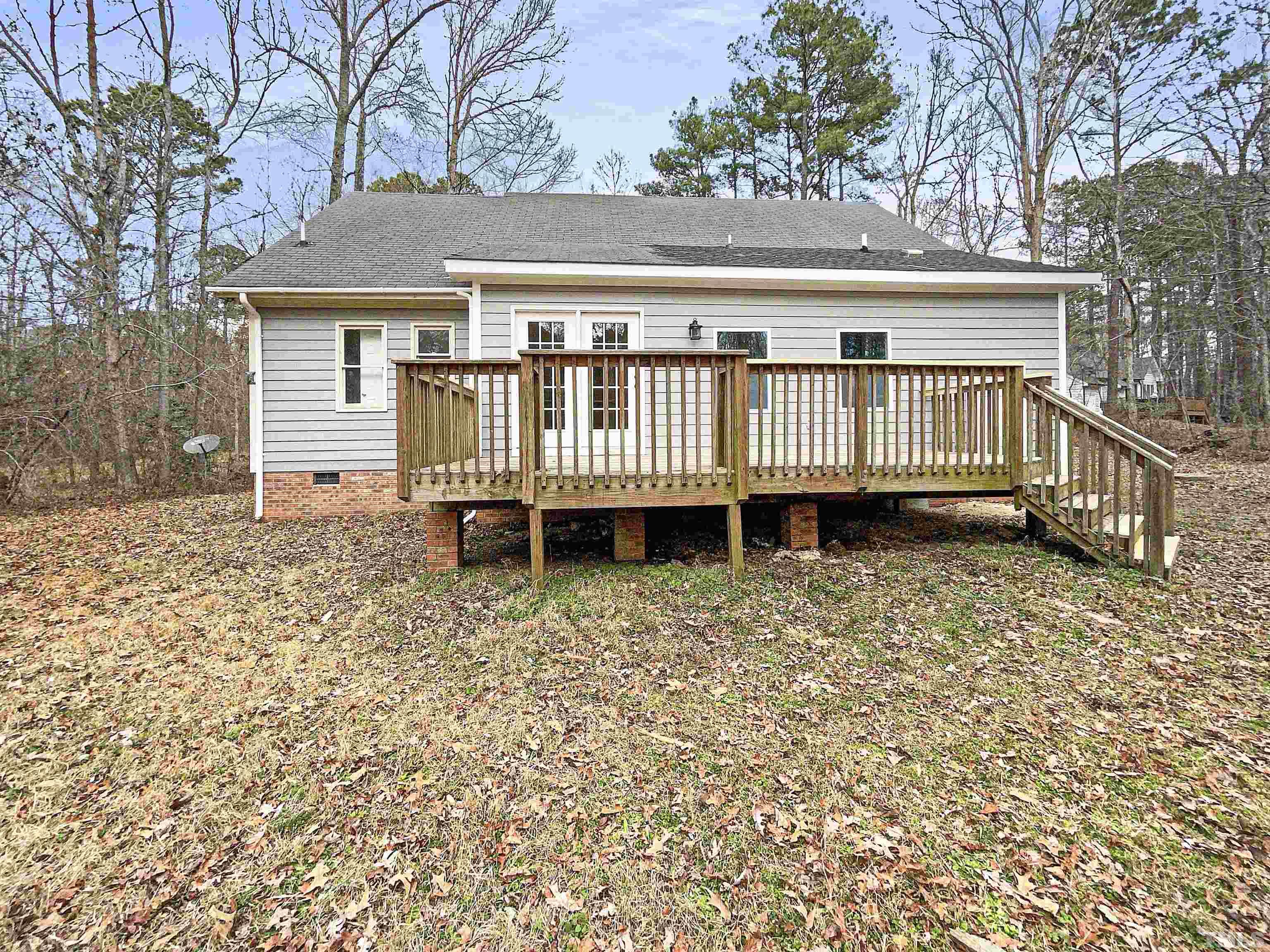 200 Lassiter Farm Road Raleigh, NC 27603 - Photo 5 of 19 a view of a house with a yard and deck area