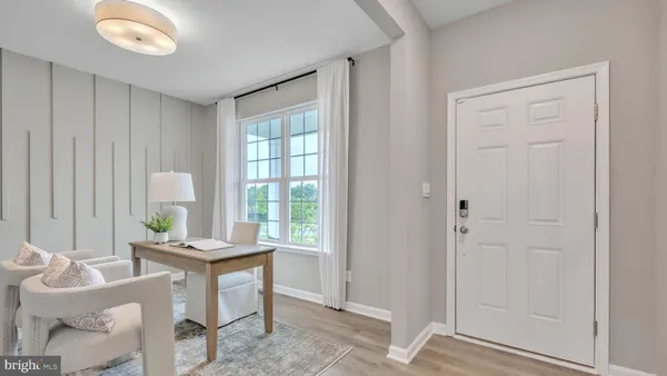 a kitchen with white cabinets and wooden floor