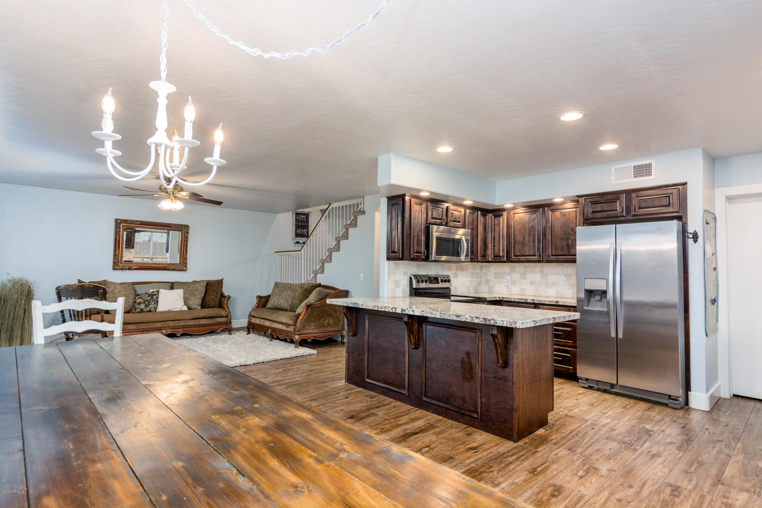 2644 East Del Rio Street Gilbert, AZ 85295 - Photo 12 of 42 a kitchen with stainless steel appliances granite countertop a refrigerator and a stove top oven
