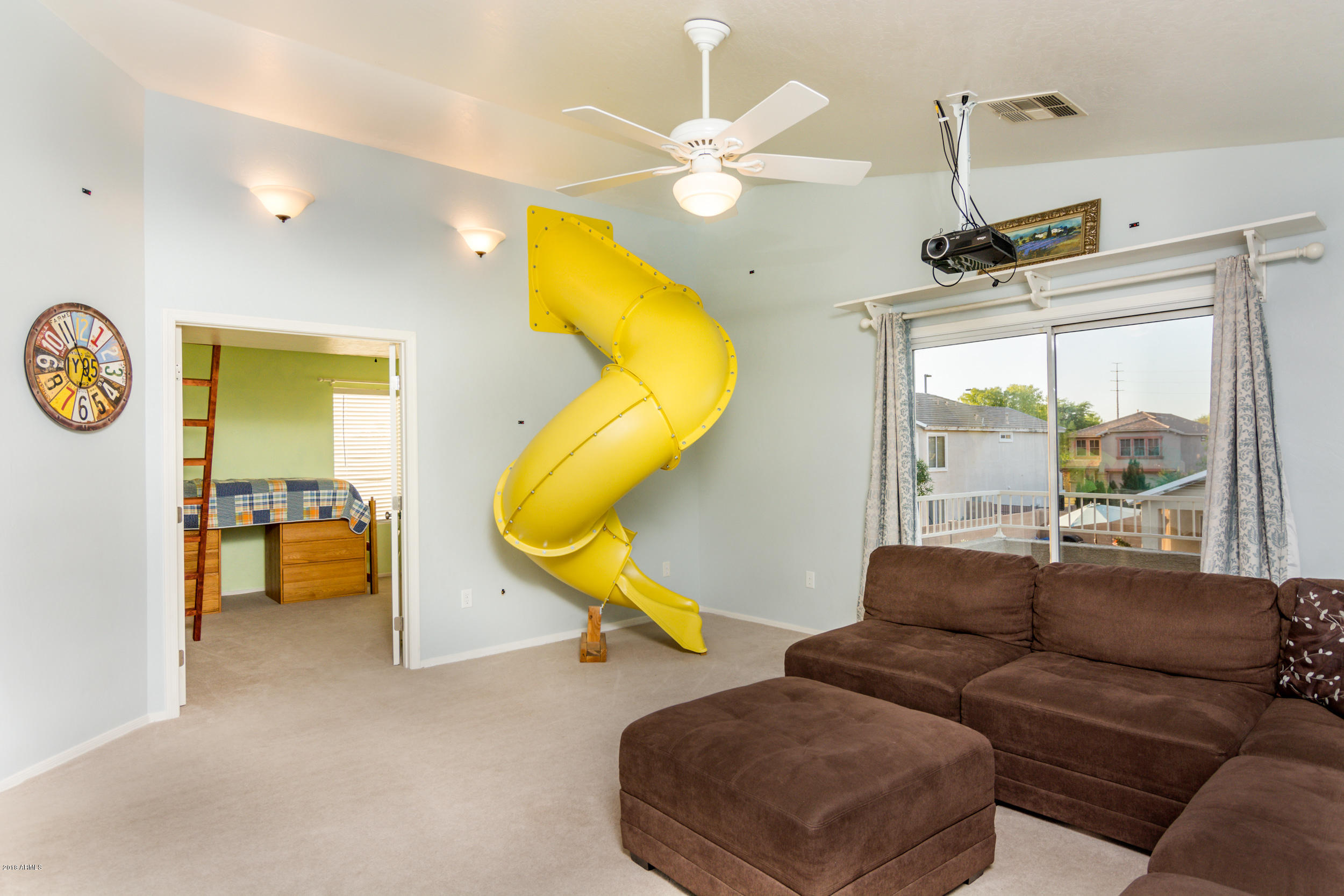 2644 East Del Rio Street Gilbert, AZ 85295 - Photo 22 of 42 a living room with furniture a ceiling fan and a large window