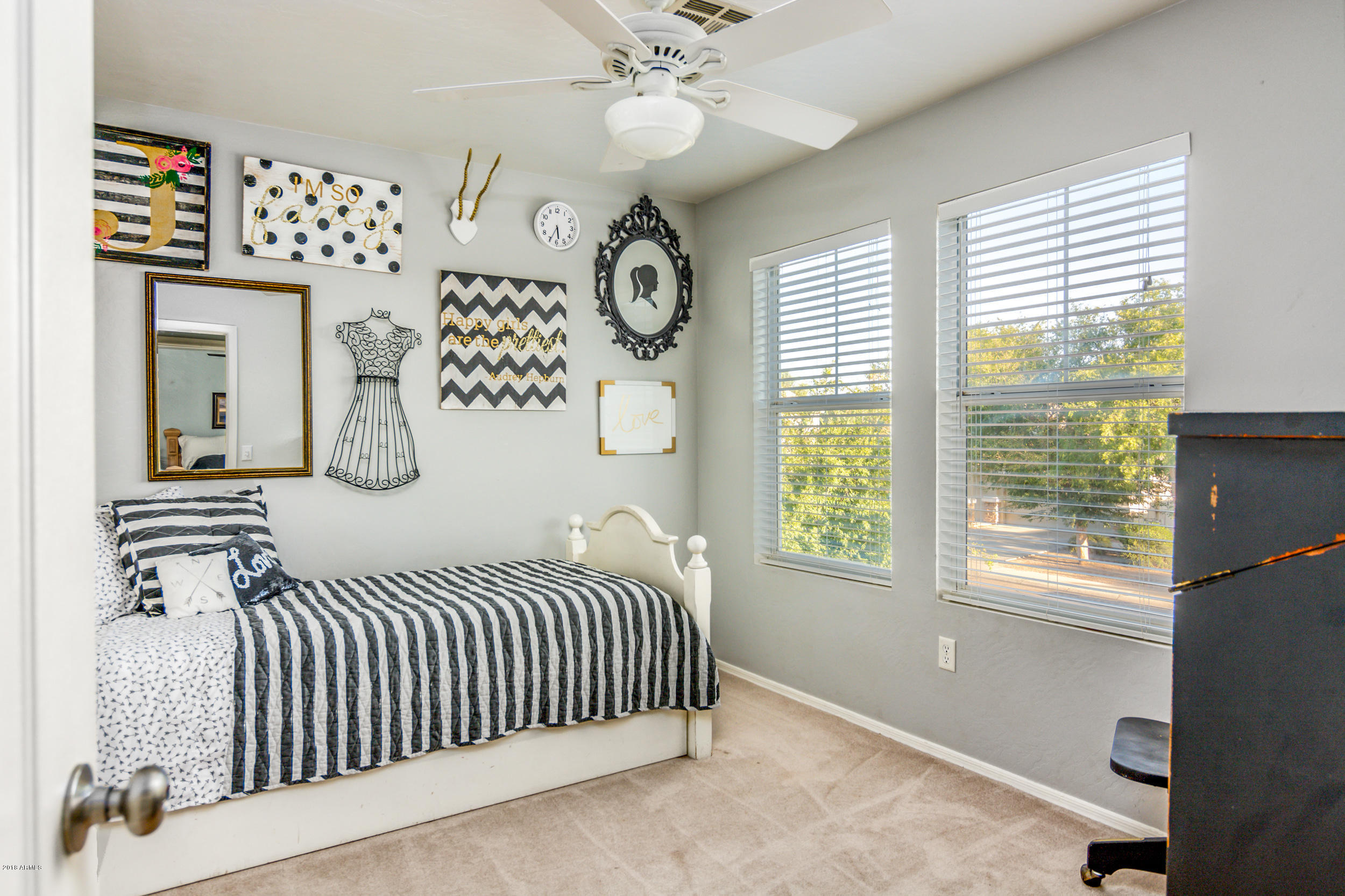 2644 East Del Rio Street Gilbert, AZ 85295 - Photo 27 of 42 a bedroom with a large bed and a chandelier