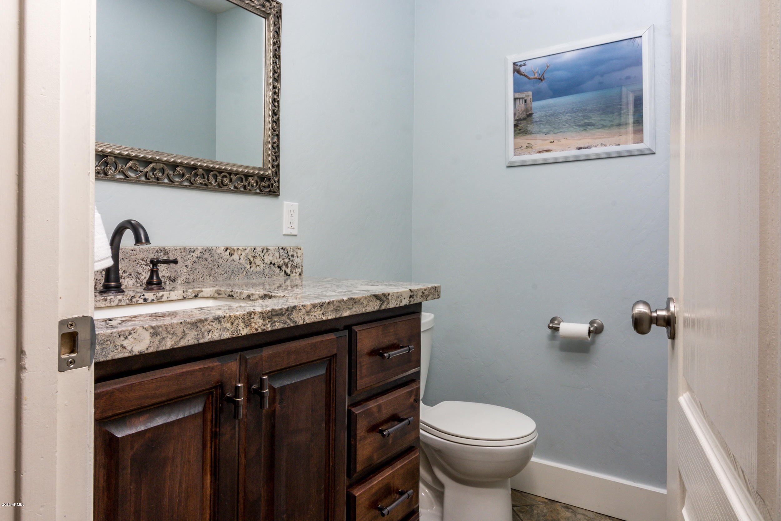 2644 East Del Rio Street Gilbert, AZ 85295 - Photo 33 of 42 a bathroom with a granite countertop toilet sink and mirror