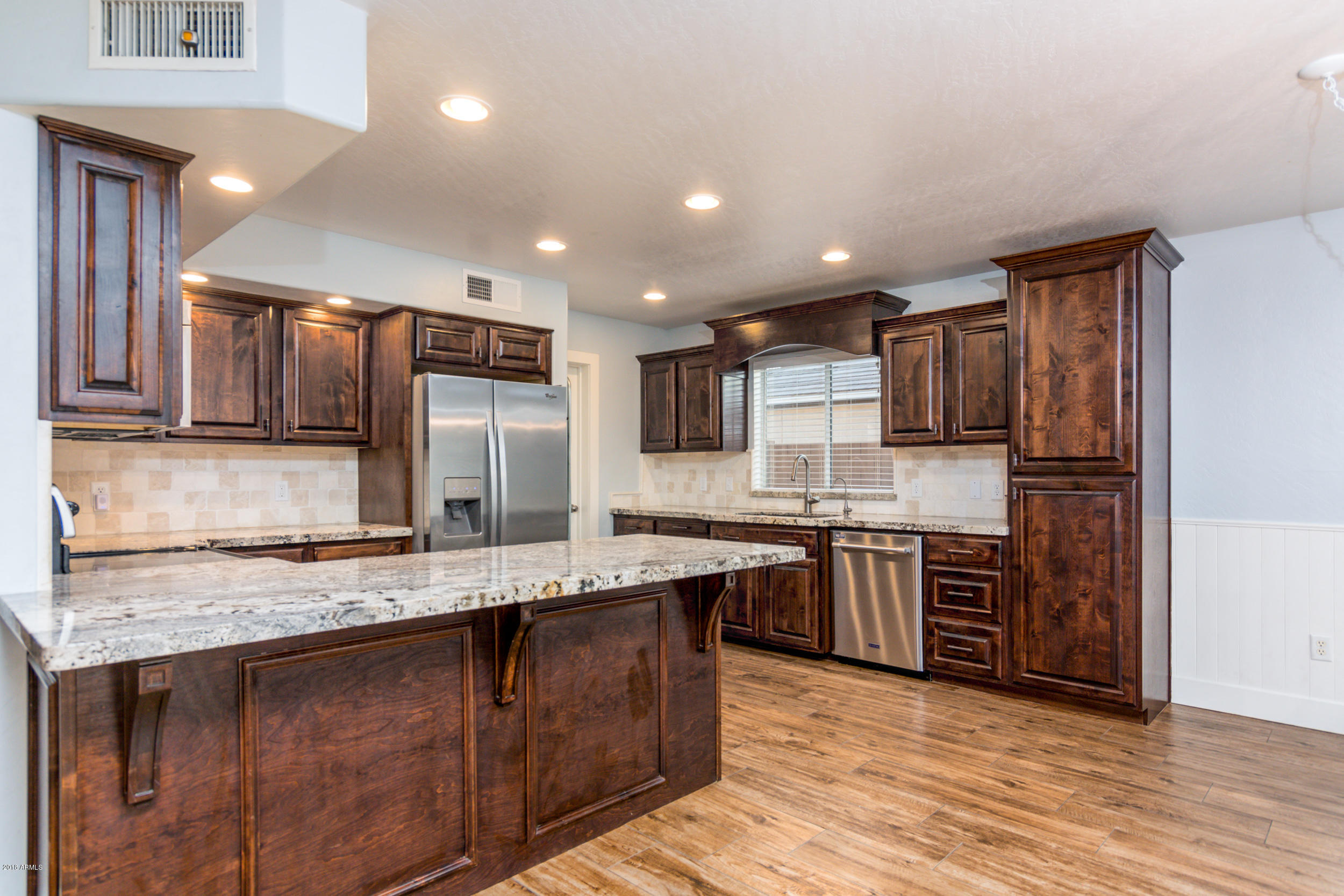 2644 East Del Rio Street Gilbert, AZ 85295 - Photo 6 of 42 a large kitchen with stainless steel appliances granite countertop a sink and cabinets