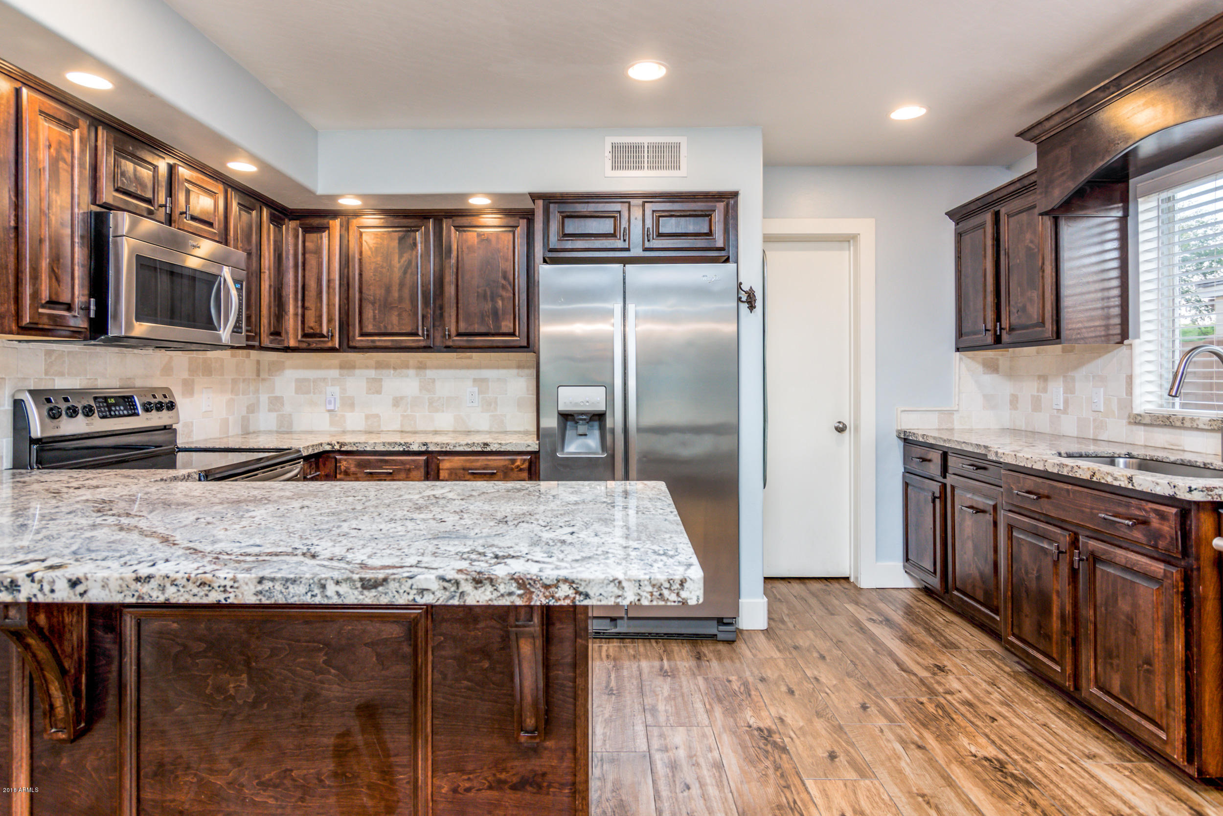 2644 East Del Rio Street Gilbert, AZ 85295 - Photo 7 of 42 a kitchen with stainless steel appliances granite countertop a sink stove and refrigerator
