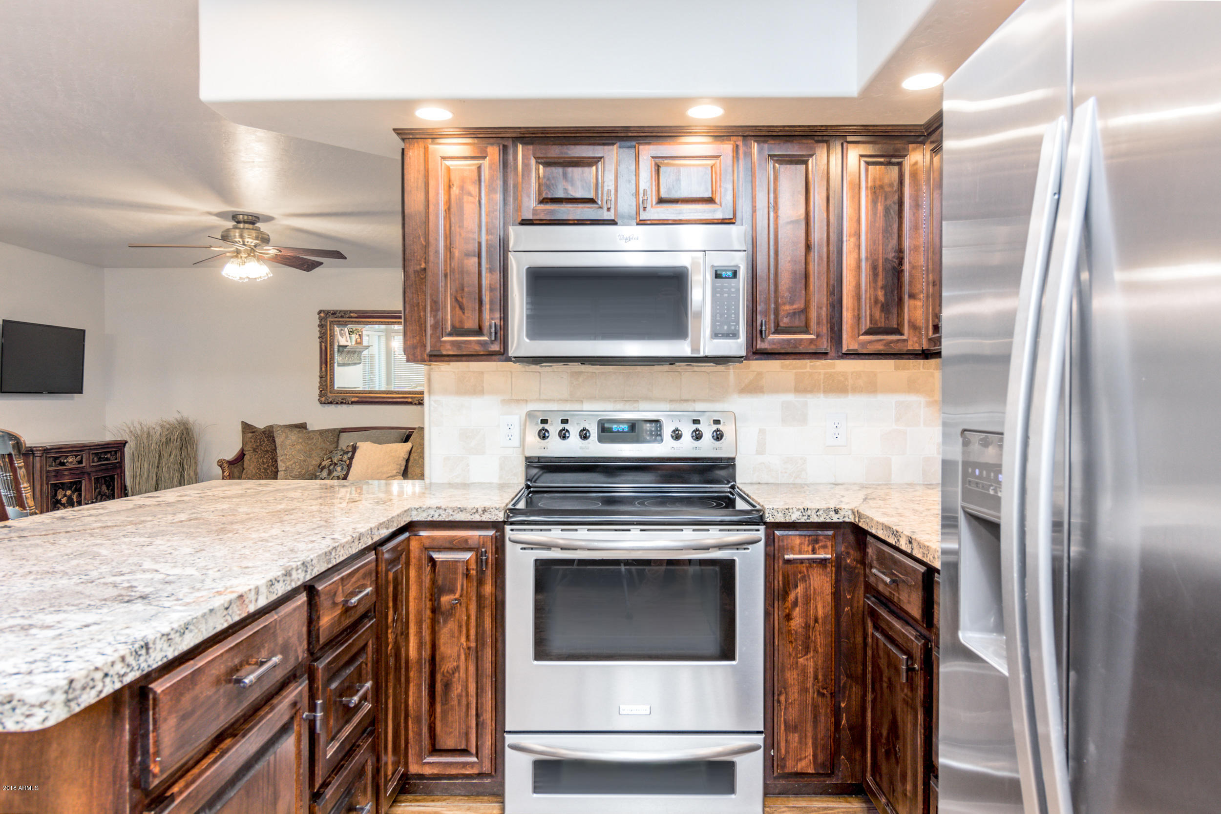2644 East Del Rio Street Gilbert, AZ 85295 - Photo 8 of 42 a kitchen with granite countertop a stove and a refrigerator
