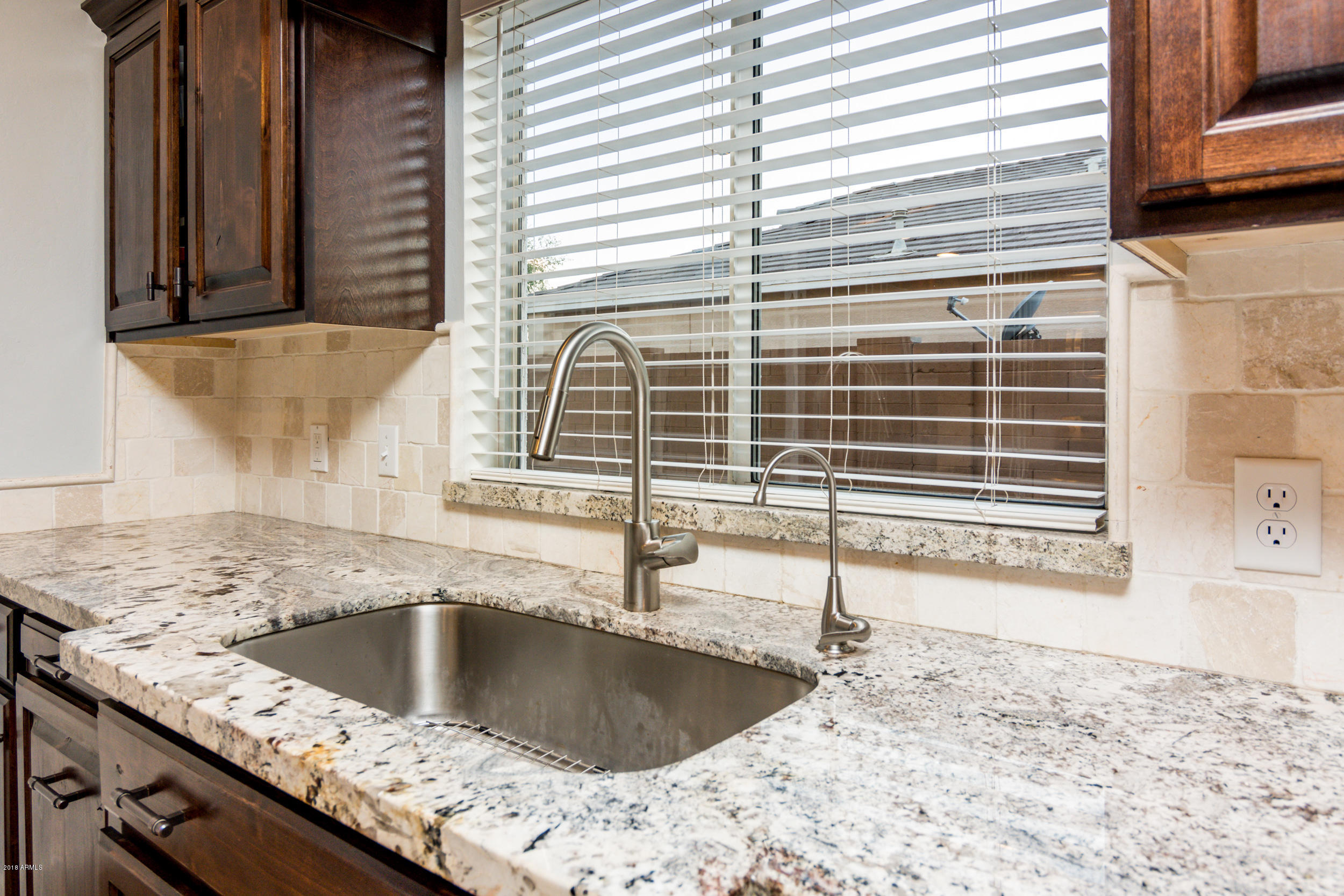 2644 East Del Rio Street Gilbert, AZ 85295 - Photo 10 of 42 a kitchen with a granite countertop sink and a window