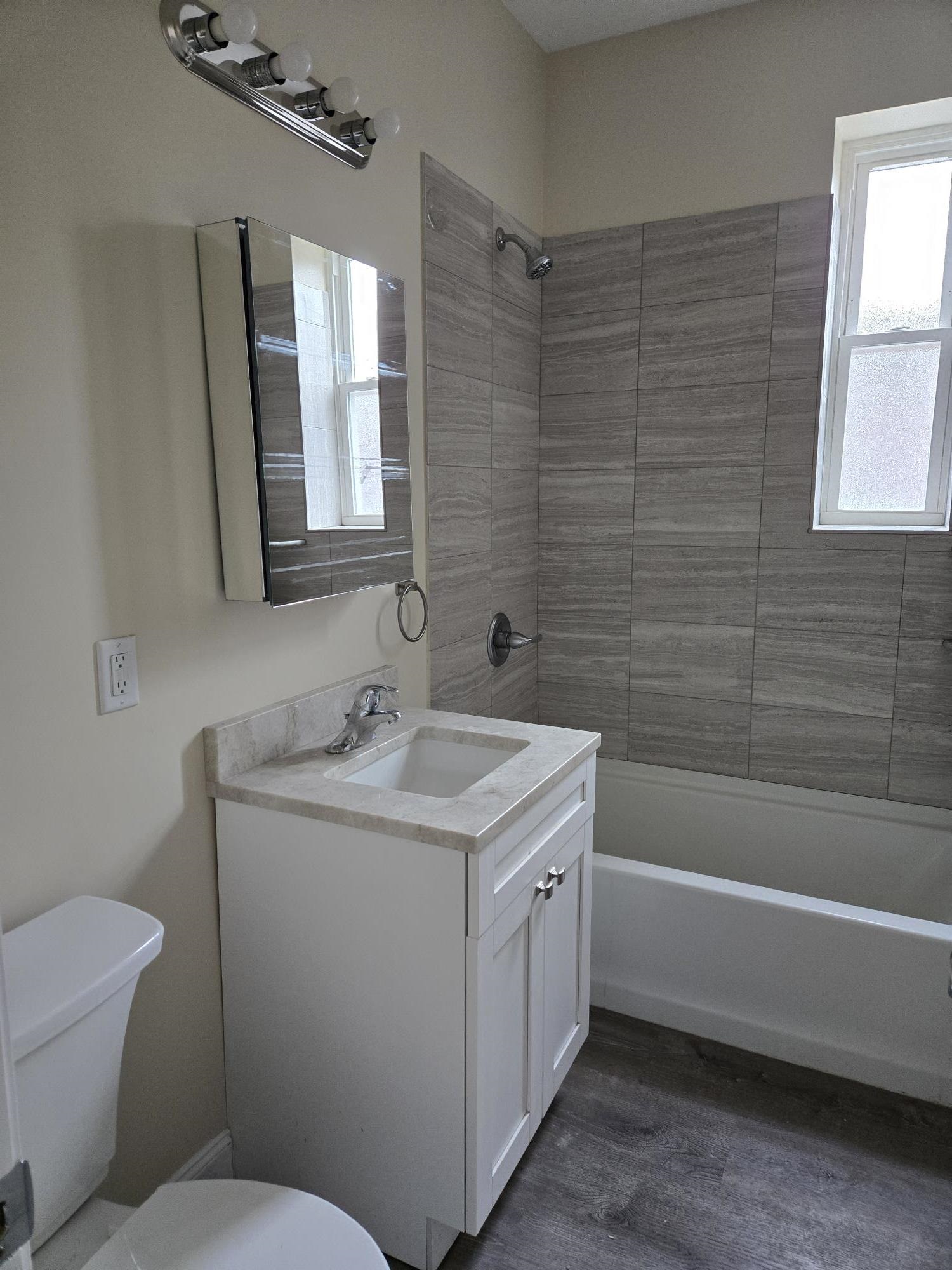 289 Day Avenue, Unit B2 Fairview, NJ 07022 - Photo 4 of 6 a bathroom with a sink toilet vanity and tub