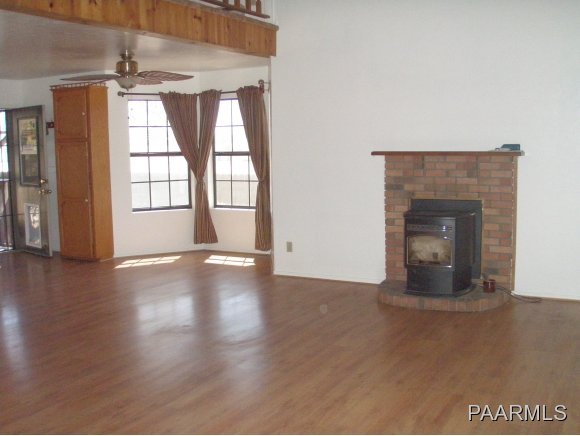 2895 North Reed Road, Unit 1 Chino Valley, AZ 86323 - Photo 8 of 22 a view of an empty room with wooden floor and a window