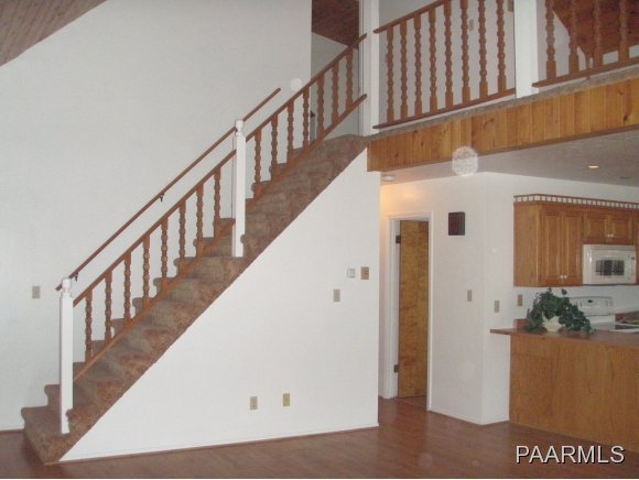 2895 North Reed Road, Unit 1 Chino Valley, AZ 86323 - Photo 10 of 22 a view of staircase with lots of frames on wall and wooden floor