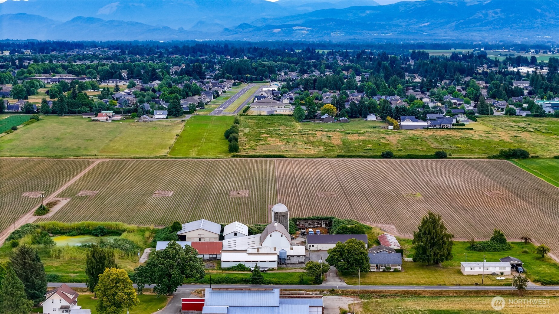 8634 Double Ditch Road Lynden, WA 98264 - Photo 30 of 40 an aerial view of residential houses with outdoor space and parking