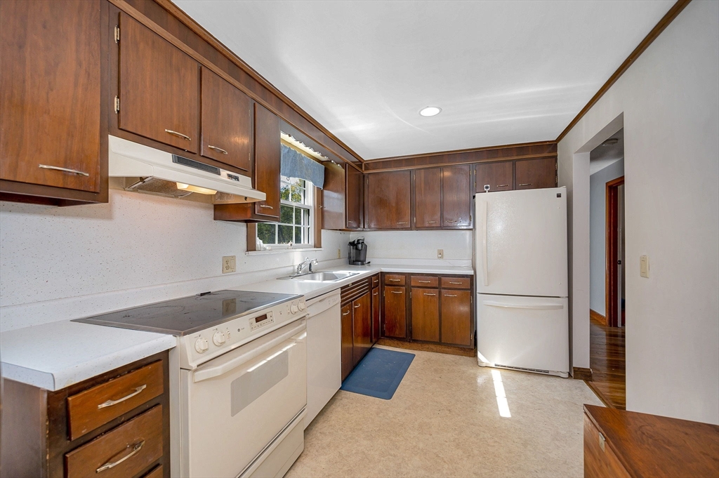 24 Arcadia Road Billerica, MA 01821 - Photo 4 of 24 a kitchen with a sink a refrigerator and cabinets