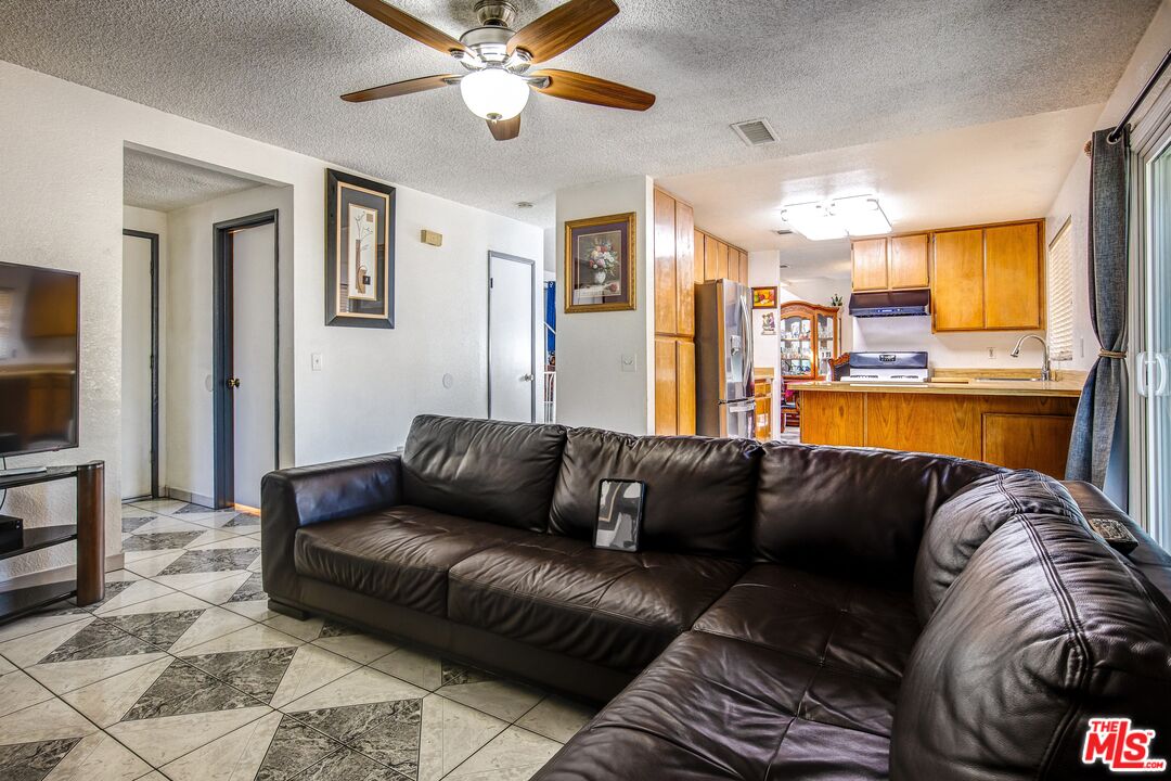 981 West Long Beach Drive Colton, CA 92324 - Photo 13 of 33 a living room with furniture and a large window
