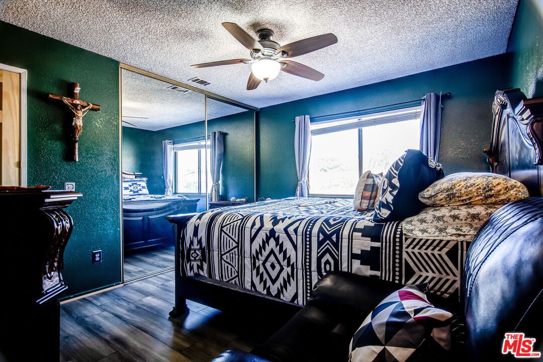 981 West Long Beach Drive Colton, CA 92324 - Photo 18 of 33 a bedroom with a bed and a chandelier