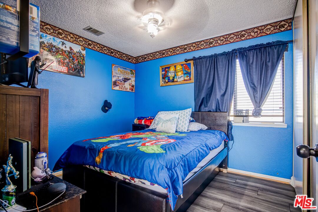 981 West Long Beach Drive Colton, CA 92324 - Photo 21 of 33 a bedroom with a bed and a window