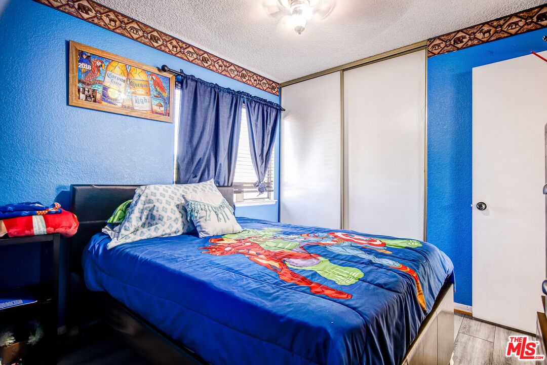 981 West Long Beach Drive Colton, CA 92324 - Photo 22 of 33 a bedroom with a bed and a table in it