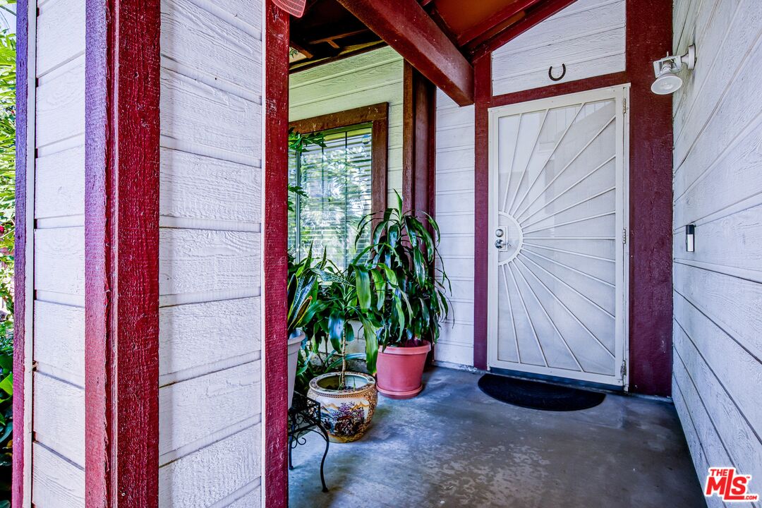 981 West Long Beach Drive Colton, CA 92324 - Photo 3 of 33 a potted plant in front of a door