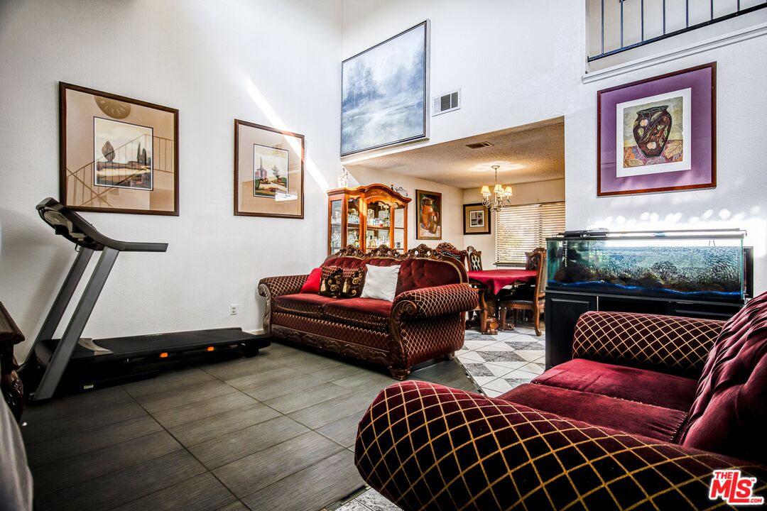 981 West Long Beach Drive Colton, CA 92324 - Photo 4 of 33 a living room with furniture a rug and wall paintings