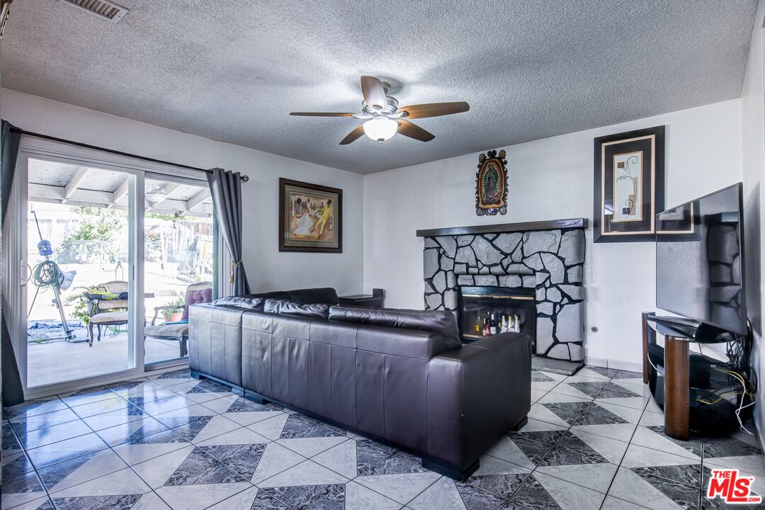 981 West Long Beach Drive Colton, CA 92324 - Photo 10 of 33 a kitchen with granite countertop a refrigerator a stove top oven a sink a dining table and chairs