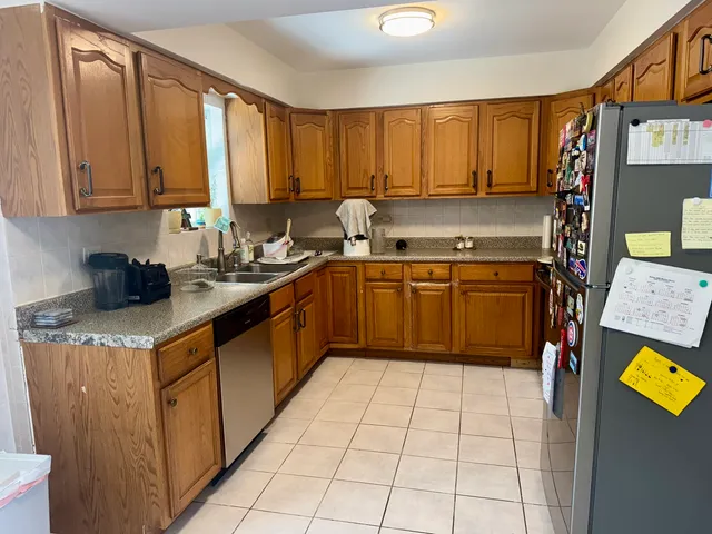 a kitchen with stainless steel appliances granite countertop a sink counter space cabinets and a window