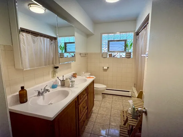 a bathroom with a sink mirror and a bathtub