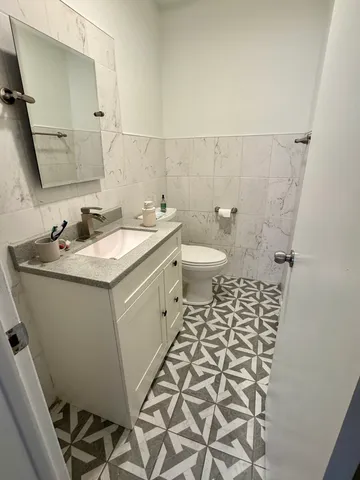 a bathroom with a sink toilet and mirror