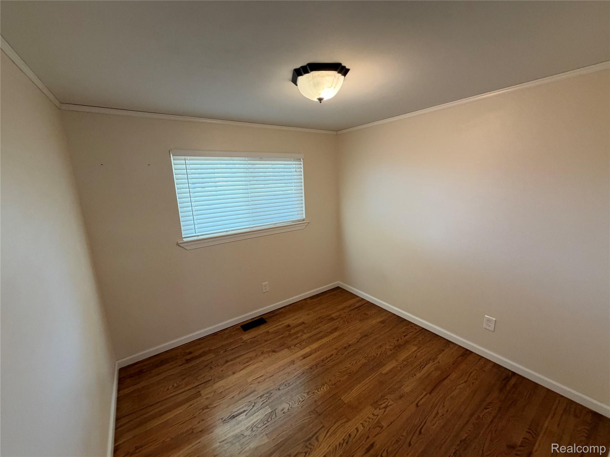 14629 Newburgh Road Livonia, MI 48154 - Photo 13 of 27 Hardwood flooring, painted walls, window with blinds, ceiling-mounted light fixture, crown molding