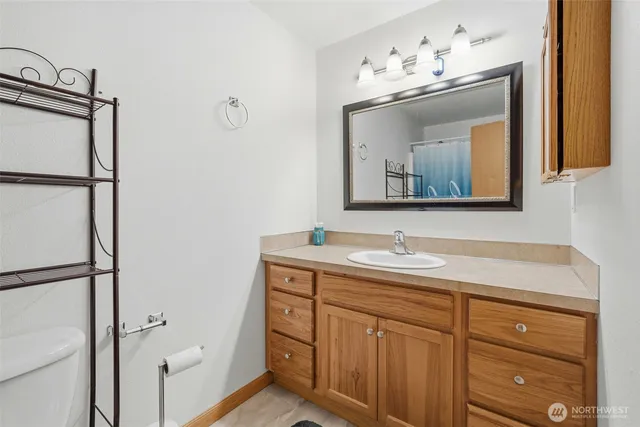 a bathroom with a sink vanity and mirror