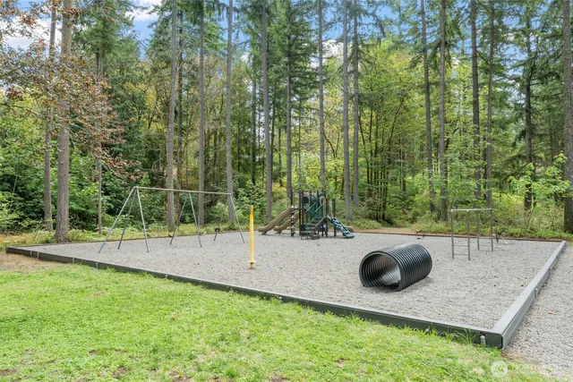 a view of a backyard with table and chairs