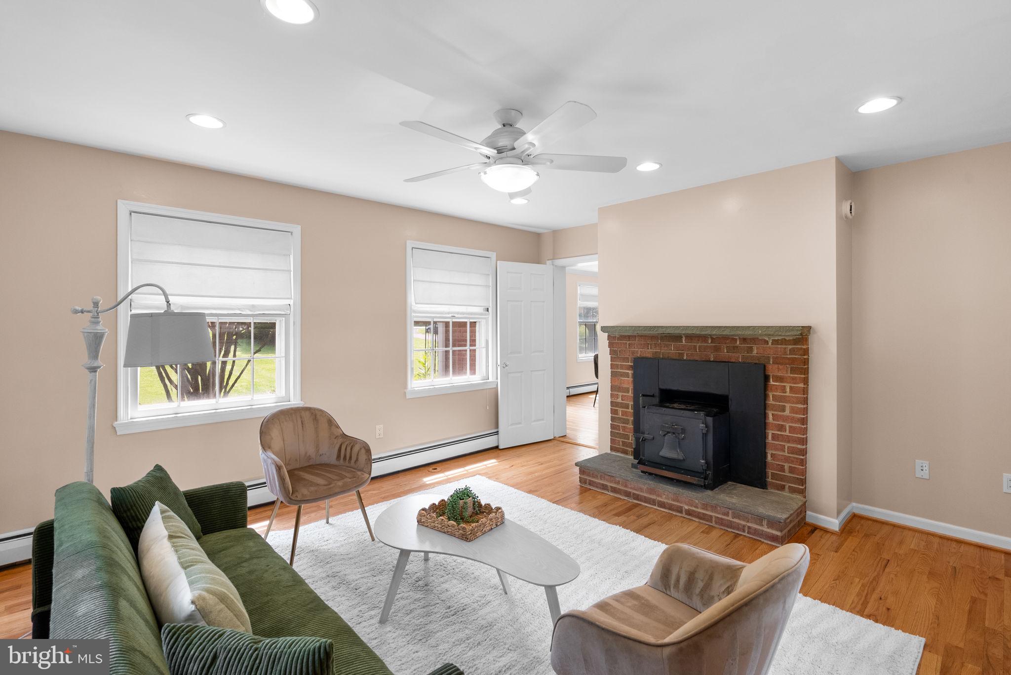 211 Olney Sandy Spring Road Ashton, MD 20861 - Photo 12 of 49 a living room with furniture and a fireplace