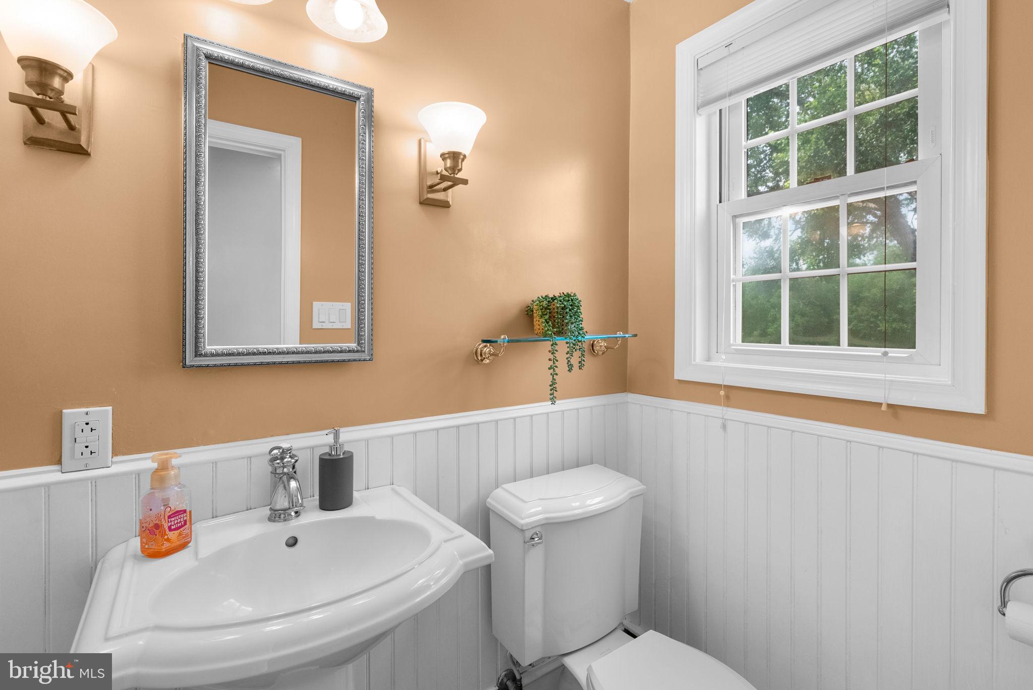 211 Olney Sandy Spring Road Ashton, MD 20861 - Photo 13 of 49 a bathroom with a sink and a mirror