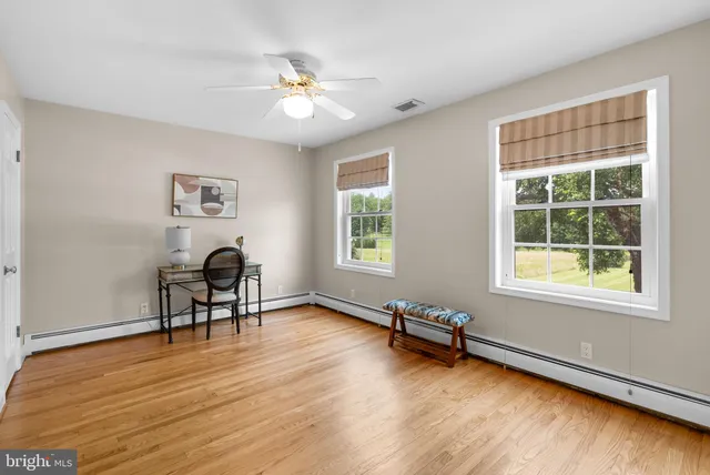 a view of a livingroom with wooden floor and a window