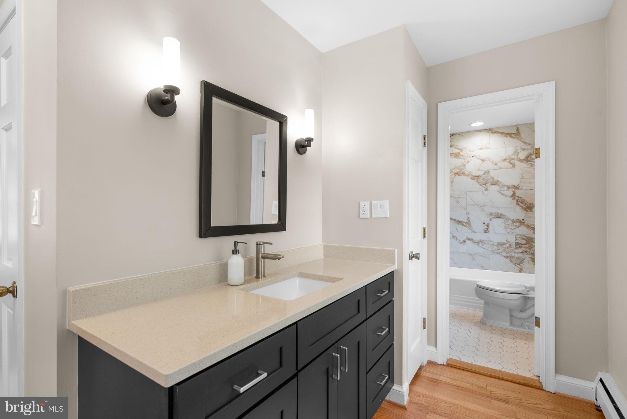 211 Olney Sandy Spring Road Ashton, MD 20861 - Photo 20 of 49 a bathroom with a sink a toilet and shower