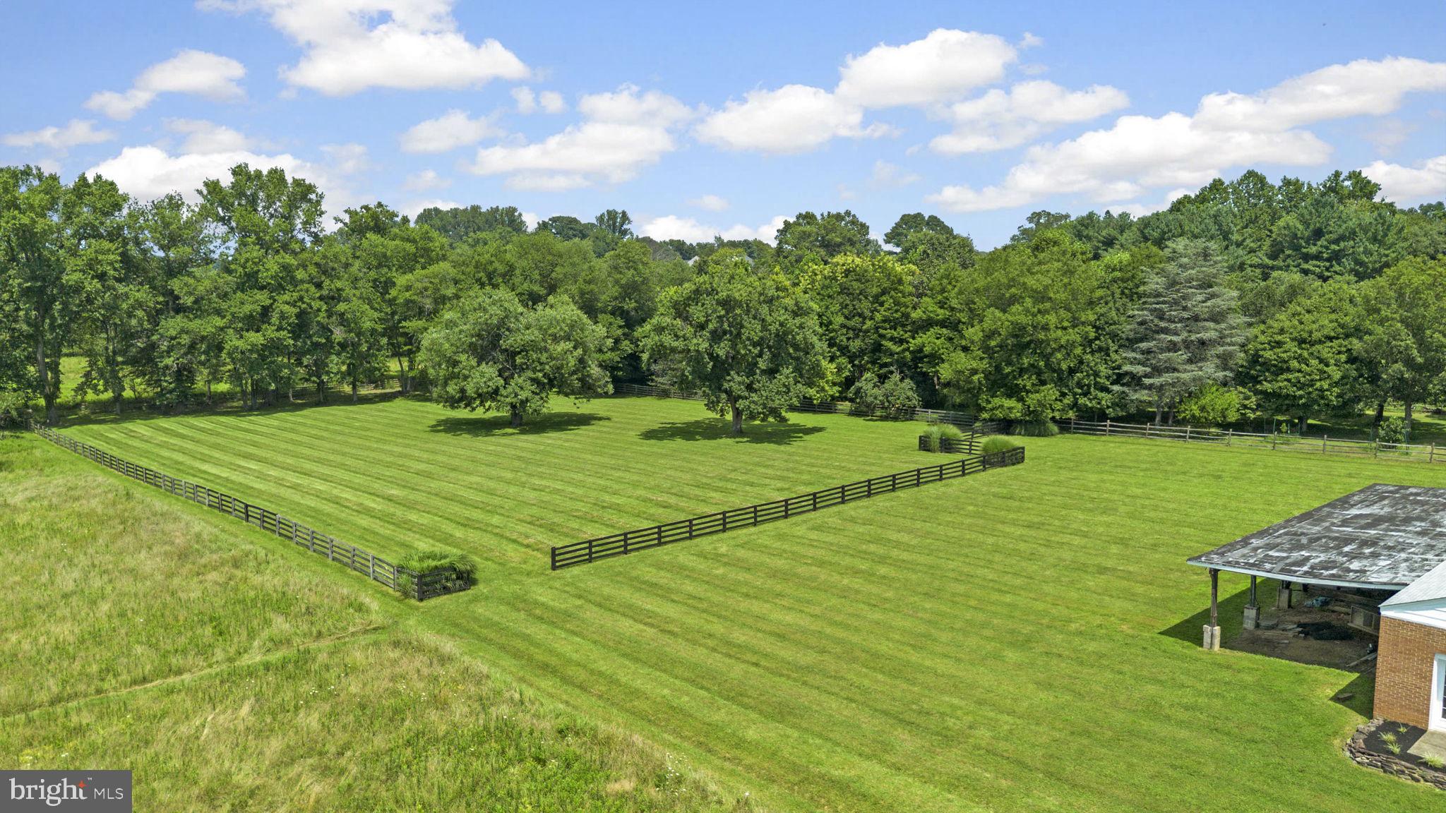 211 Olney Sandy Spring Road Ashton, MD 20861 - Photo 2 of 49 a view of a green field with wooden fence