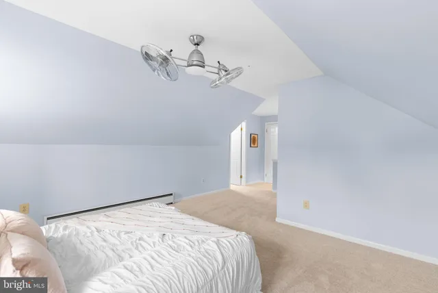 a bedroom with a bed and chandelier