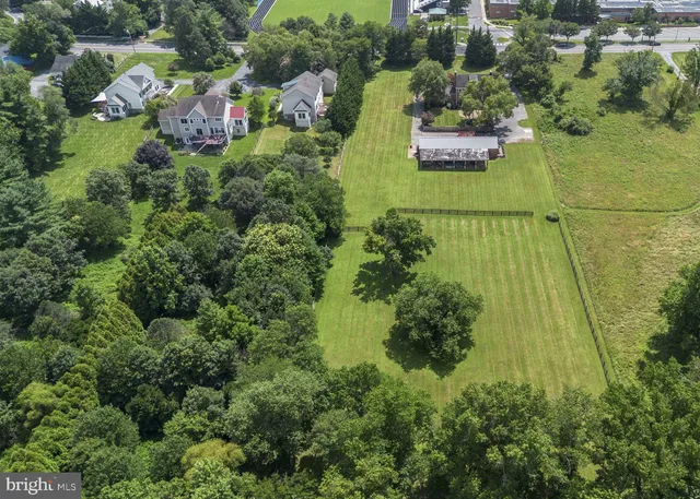 an aerial view of residential house with outdoor space and swimming pool