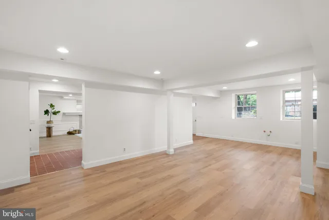 a view of empty room with wooden floor