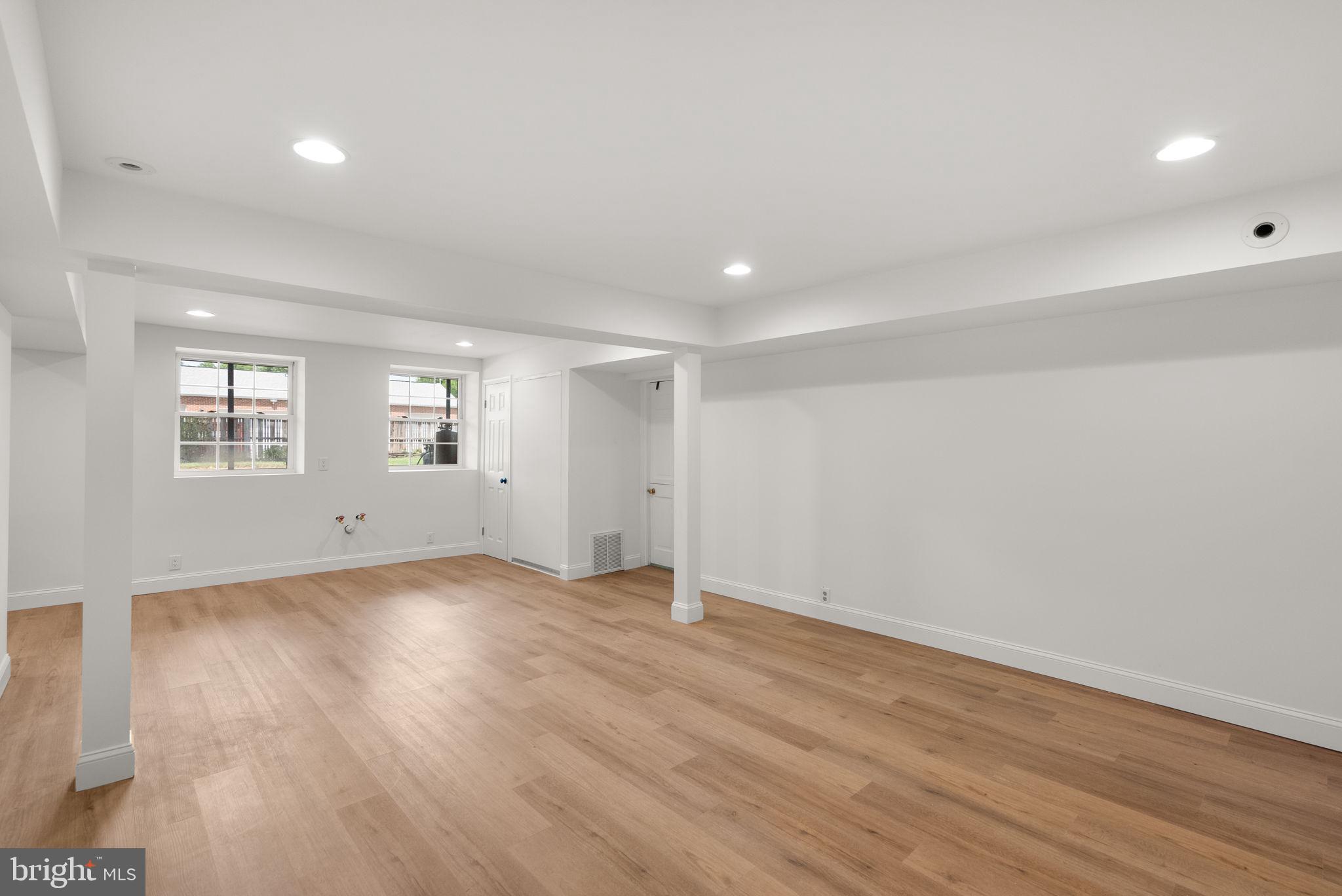 211 Olney Sandy Spring Road Ashton, MD 20861 - Photo 33 of 49 an empty room with wooden floor and windows