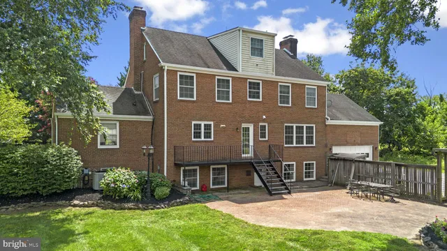 a view of a house with a yard and sitting area