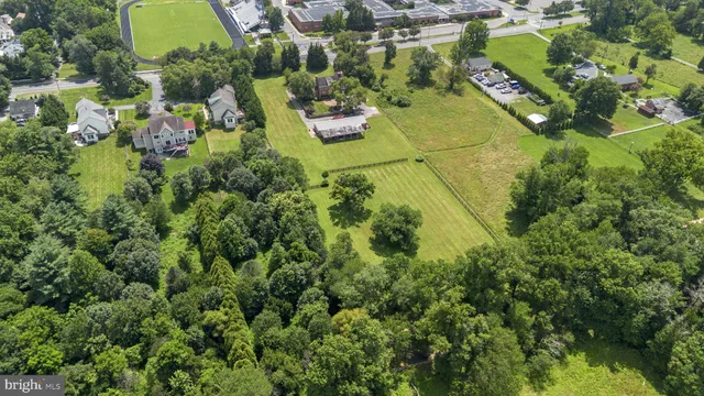 an aerial view of residential house with outdoor space and swimming pool