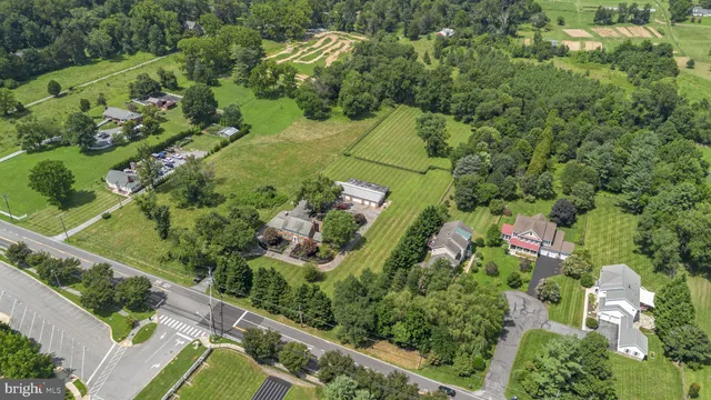 an aerial view of a house with a yard and outdoor seating
