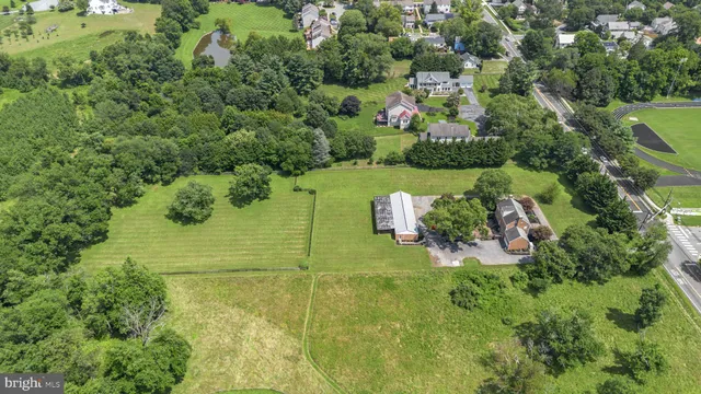 an aerial view of a residential houses with yard