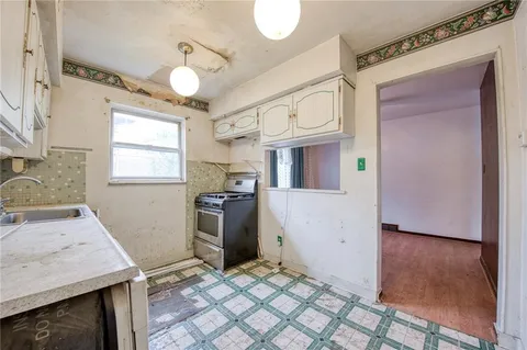 a view of kitchen with window and stainless steel appliances