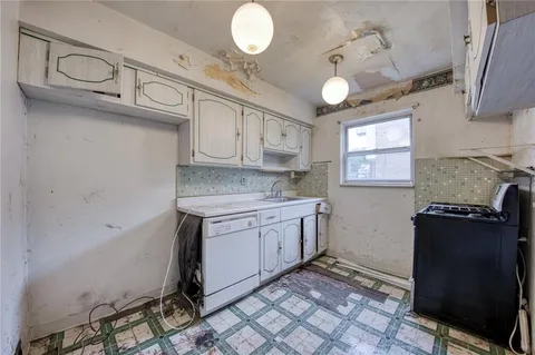 a kitchen with stainless steel appliances granite countertop a sink and cabinets