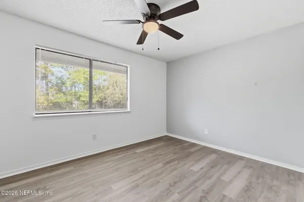 a view of a workspace with furniture and a ceiling fan