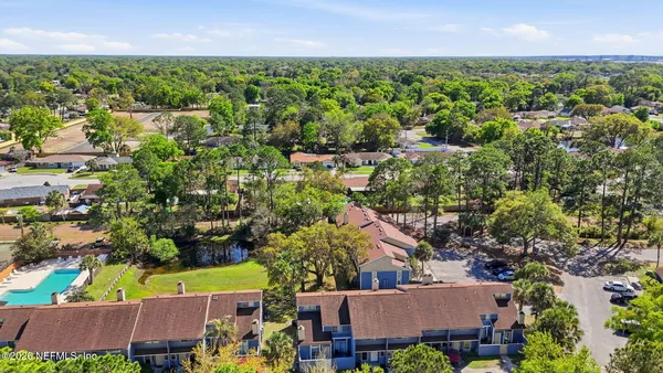 an aerial view of residential houses with outdoor space
