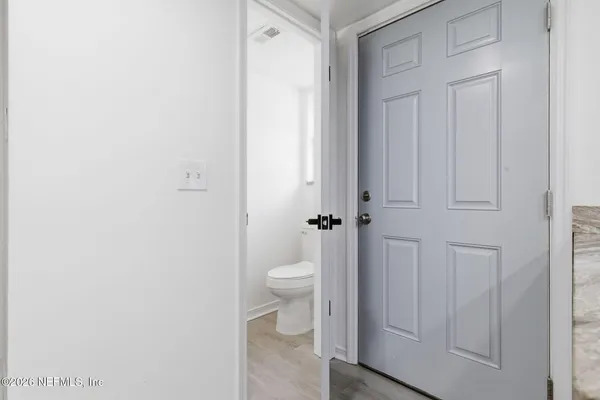 a bathroom with a granite countertop sink and a window